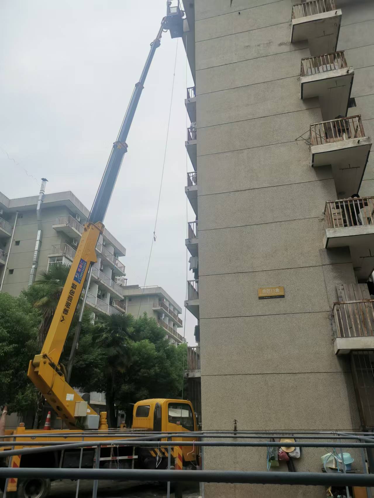 24米高空作業(yè)車(chē)安裝小區(qū)樓棟標(biāo)識(shí)牌施工現(xiàn)場(chǎng)